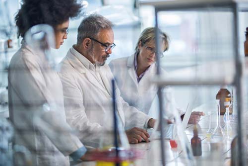 3 biochemists working in the lab