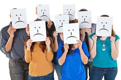 Group of People Holding Sad Face Signs Up