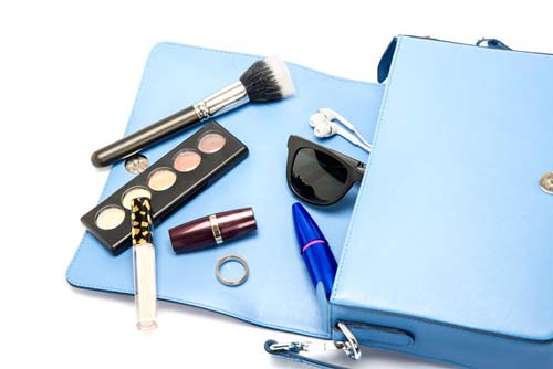 Blue purse with makeup inside