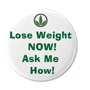 A Herbalife pin that says "Lose Weight Now! Ask Me How!"