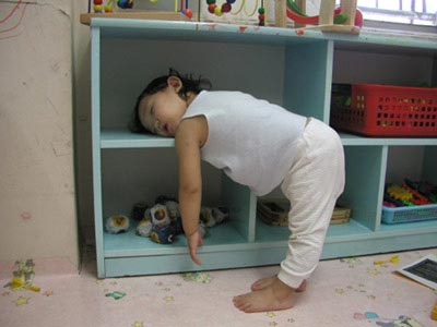 young child sleeping while standing